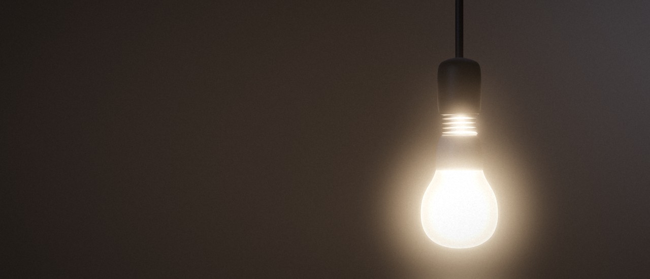 A pendant light bulb glowing warm white in a dark bedroom. Use the Bedroom control to turn it on or off and change its brightness and color.